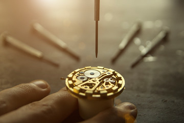 Watchmaker is fixing a wristwatch
