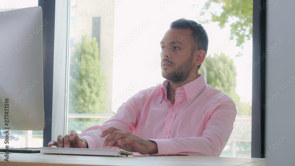Aufkleber portrait mixed race man working at home office. adult man typing on keyboard looking on monitor comp