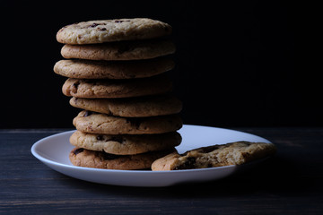 American chocolate chip cookies. Cookies, a glass of milk and a linen towel. Rustic still life.
