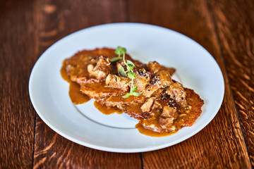 Fried potato pancakes with meat sauce