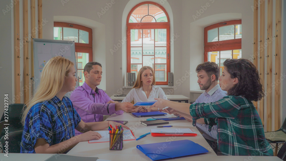 Poster diverse team discussing development strategy in modern office. businessman and businesswoman have ne