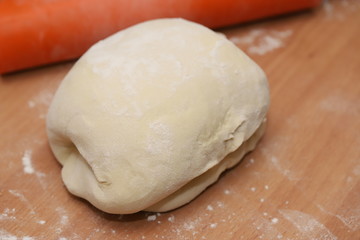 White flour dough is on the table.