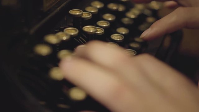 Close-up male hands typing on a printing machine. Old typewriter