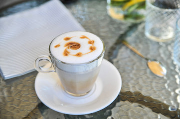 Cup of latte on glass table. Latte Art. 