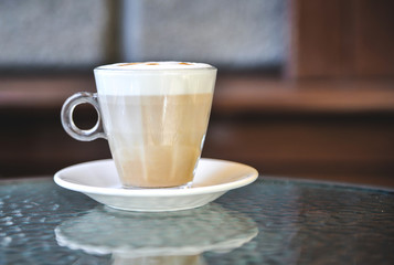 Cup of latte on glass table. Latte Art. 