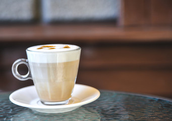 Cup of latte on glass table. Latte Art. 