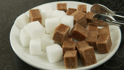 A set of white and brown sugar on a plate, a slow panorama. 4K UHD 3840x2160 Video Clip
