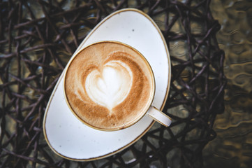Cup of latte on glass table. Latte Art. 