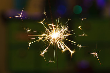 Obraz premium Sparks from hand cold fireworks color background