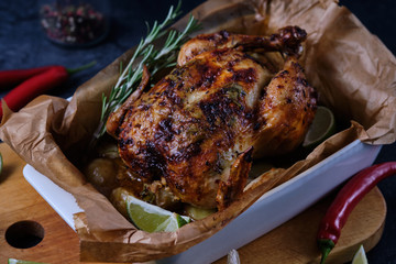 Chicken baked in the oven with spices, lemon, herbs and young potatoes.