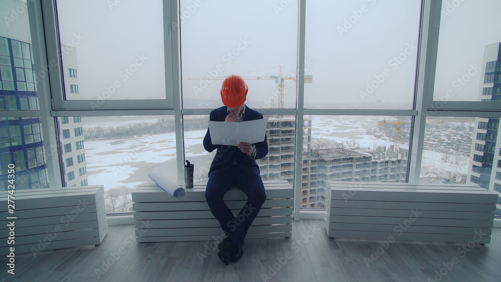 Aufkleber building engineer or architect have a break enjoy coffee holding documents. handsome man wearing in 