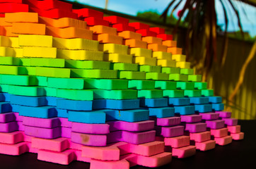 Rainbow stripes, steps with leaves, futurism abstraction on a black background