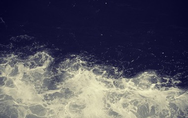 Close up on a boat wake in black and white, in deep ocean water