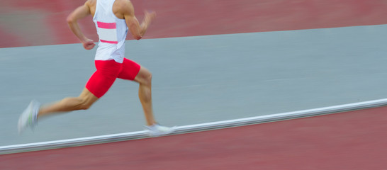 Motion blurred view of a man running