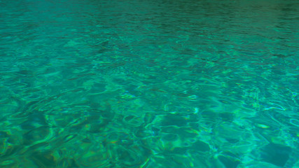 Fototapeta na wymiar Water in the pool, sunlight is reflected, small waves, Shot from a tripod 4k video