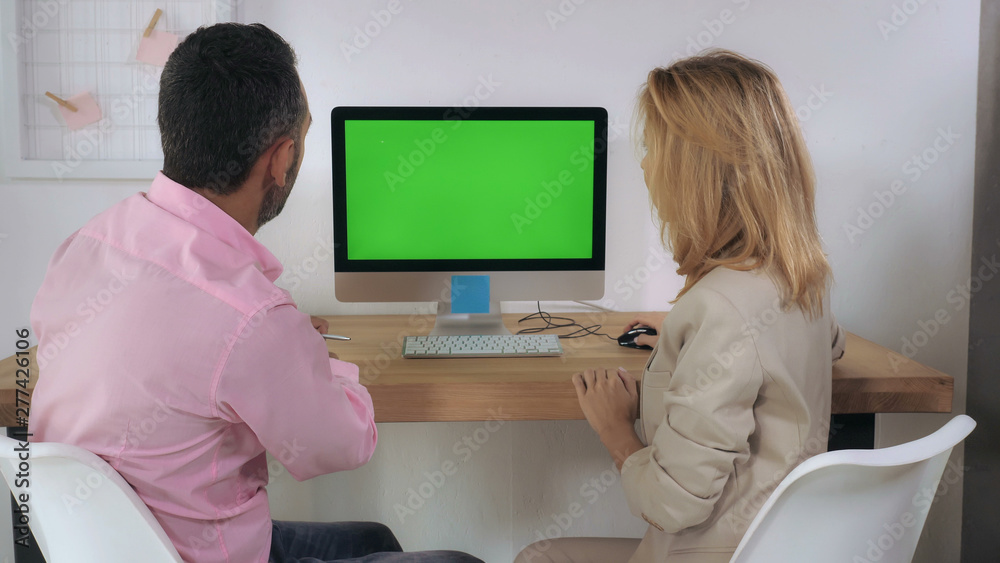 Poster business people sitting at the desk in front of computer with green screen have conversation. meetin