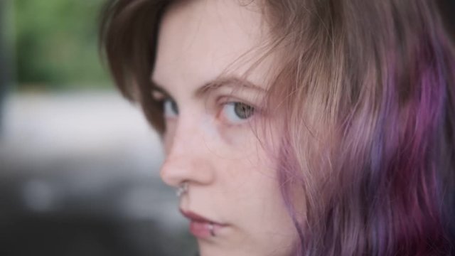 Close-up portrait of hipster girl with pierced and colored hair.
