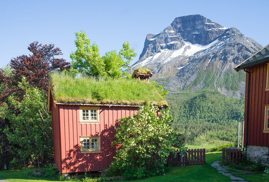 Norwegian wooden houses with green roofs and view at Satbakkollen - a 1,632-metre (5,354 ft) tall mountain in Sunndal Municipality  Trollheimen mountain range, north of the Sunndalen valley. Norway.