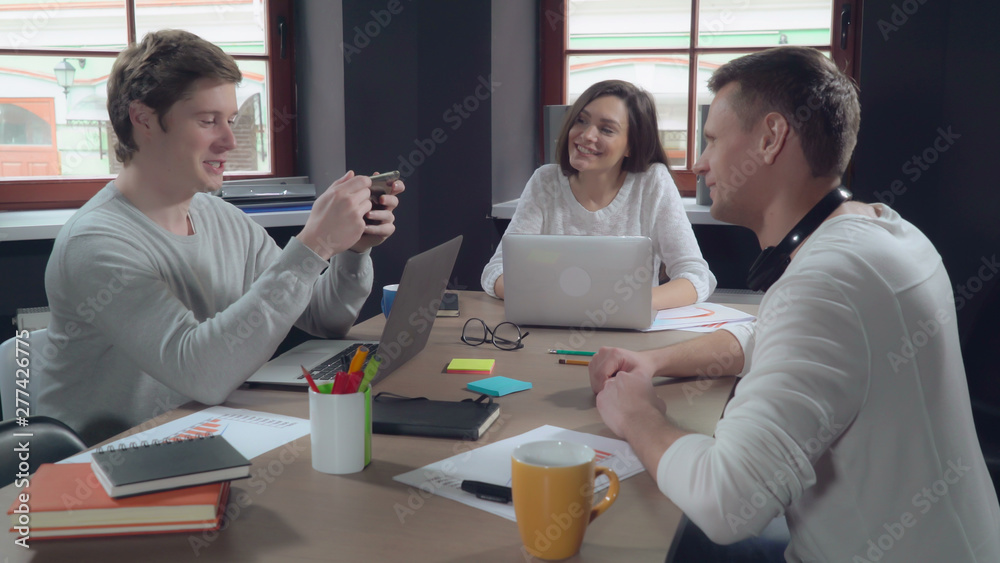 Poster casual business team discussing project in modern office. young and creative people with happy frien