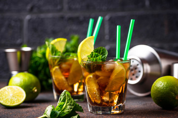 Cuba libre cocktail with mint and lime