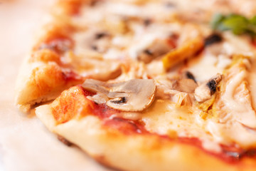 Pizza with mushrooms close-up in defocus