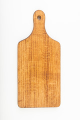 Dark wooden kitchen board on a white table. Old kitchen accessories.