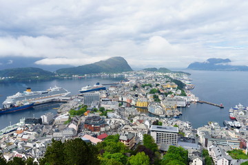 From the bird's eye view of Alesund port town on the west coast of Norway, at the entrance to the Geirangerfjord. Colorful sunset in the North. Traveling concept background