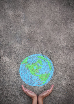 Closeup hands holding earth draw with chalk. World harmony green peace environment earth day together concept.