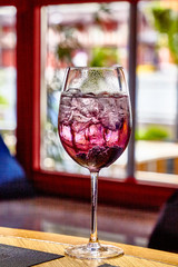 Cocktail with sparkling wine, BlackBerry and berry liqueur in a wine glass.