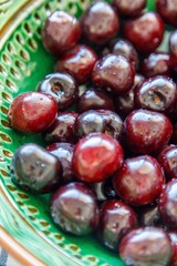 cherries ready to eat on  a green platter 