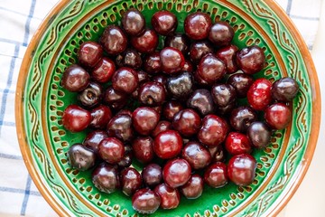 cherries ready to eat on  a green platter 