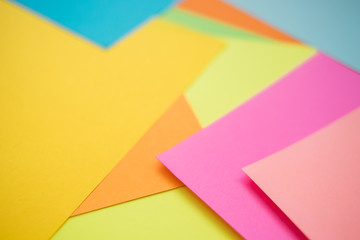 Colorful paper sheets as background, side view.