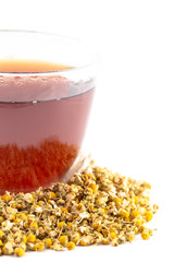 Mug of Hot Chamomile Tea with Dried Chamomile Flowers Isolated on a White Background