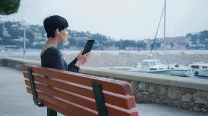 Female says greeting her friend and has a fun conversation. Caucasian model at the marina with...