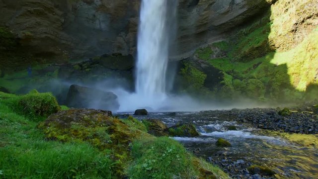 Kvernufoss waterfall in Iceland. Icelandic landscape in spring sun light.