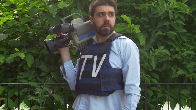 camera man walking by