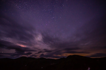 Clouds in the night sky against the background of the Milky Way