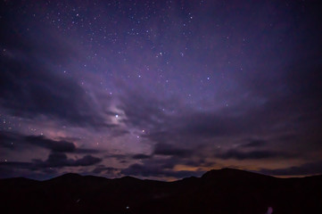 Fototapeta premium Starry sky at night over the mountains in the Carpathians
