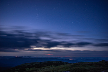 Clouds in the night sky against the background of the Milky Way