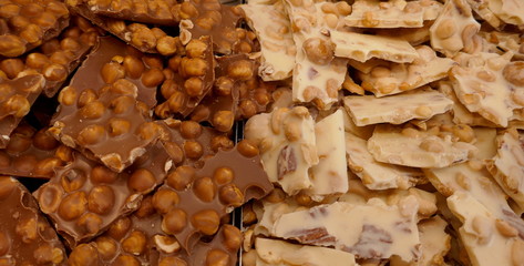 Homemade chocolate bars, light and dark, two varieties with many nuts