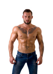 Muscular male bodybuilder standing and looking at camera, shirtless