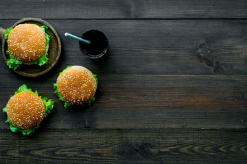 Burger on pan and drink for national american kitchen concept on wooden background top view mockup