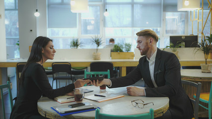 Business Partners at the meeting. Lady discusses strategy with a man. UHD video