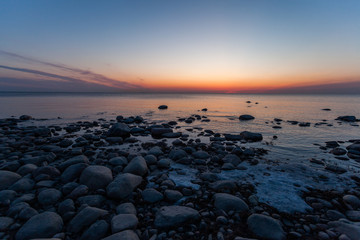 Sunrise red spring sun from the water of the lake