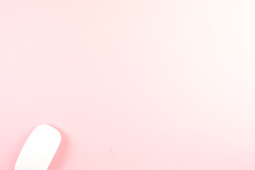 White laptop mouse over pink background.