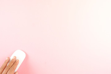 White laptop mouse over pink background.