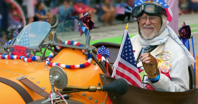 Patriotic american man cheers people at Independence Day parade, Los Angeles, 4K