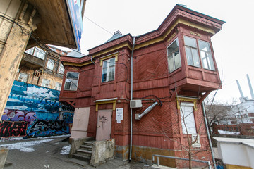 Fototapeta na wymiar The ensemble of historic wooden houses in the center of Vladivostok. Historical Foundation.