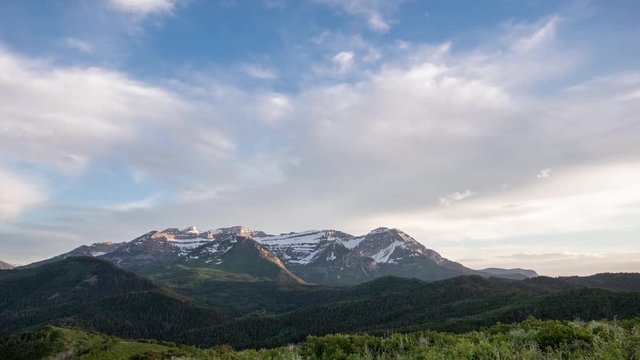 Time lapse of clouds moving over Timpanogos Mountain as the light fades at sunset viewing the backside of Timp.