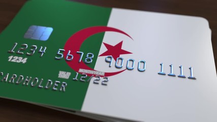 Credit card featuring flag of Algeria. Algerian national banking system related animation - Powered by Adobe